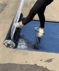 Heavy Duty Self Adhesive Roofing Tape Rock Solid Waterproof Asphalt Membrane Roll being installed with a foot push