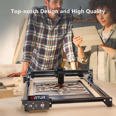Front view of ORTUR Laser Master 2 S2 LU2-10A laser engraver on a workshop table with wood pieces