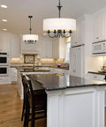 Traditional 5 Light Chrome Drum Chandelier With White Linen Shade For Dining Room shown above a modern kitchen island.
