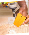 Top Shelf 100 Pack Yellow Latex Finger Sleeves being used while drilling, providing grip and protection during heavy lifting tasks.