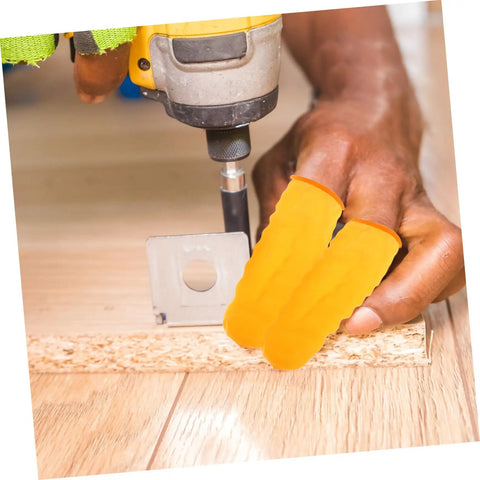Top Shelf 100 Pack Yellow Latex Finger Sleeves being used while drilling, providing grip and protection during heavy lifting tasks.