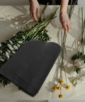 Floral Wrapping Paper Sheets 10 Pack Embossed Kraft Paper with Polka Dot Design beside flowers on table.