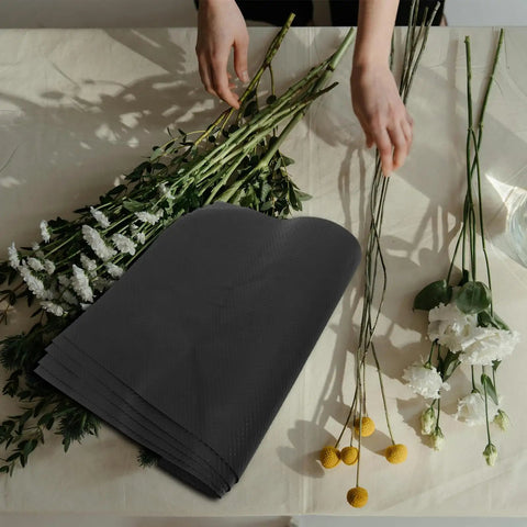 Floral Wrapping Paper Sheets 10 Pack Embossed Kraft Paper with Polka Dot Design beside flowers on table.