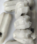 Glazed Ceramic Antenna Insulators, 22 Pack, Small Ceramic Isolators for Dipole, CB Radio and Field Day Use, close-up view