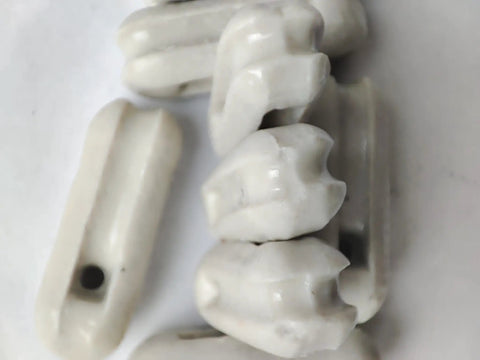 Glazed Ceramic Antenna Insulators, 22 Pack, Small Ceramic Isolators for Dipole, CB Radio and Field Day Use, close-up view