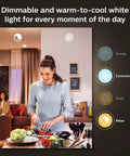 Woman cooking with dimmable White Ambiance BR30 LED Smart Bulbs With Bluetooth Control lighting in kitchen.