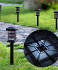 Solar Pathway Lights Outdoor LED Solar Powered Garden Lights illuminating a stone path and lawn at night, 12 Pack IP44.