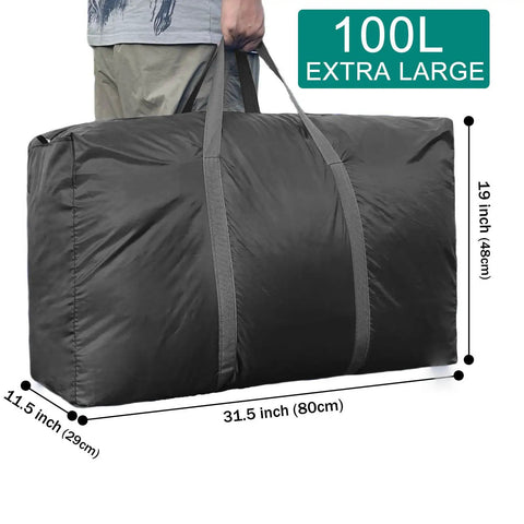 Man holding Beefy 100L Extra Large Storage Bags with Heavy Duty Zippers, sturdy handles, dimensions 31.5x11.5x19 in, black color.