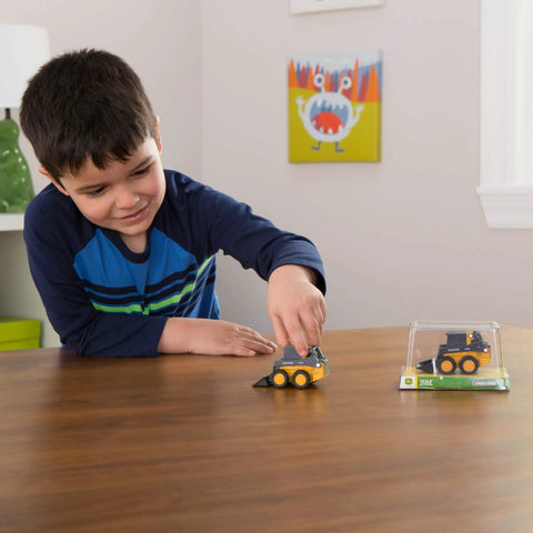 Child playing with Deluxe 3 Pack John Deere Farm Toy Set With Free Rolling Wheels Tractors Gator And Skid Steer In Collectible Display Box
