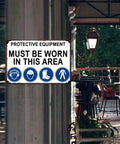 Must Wear Protective Equipment Area Aluminum Sign 8x12 Inch Durable Metal Safety Warning mounted on outdoor wall.