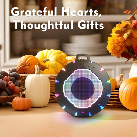 Waterproof Shower Bluetooth Speaker With IPX7 Rating, ultra portable carabiner clip, with LEDs on autumn-themed kitchen counter