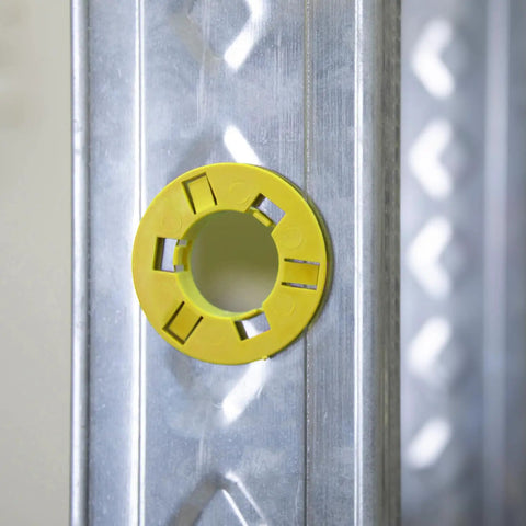 100 Pack Yellow Snap Fit Bushings For Metal Studs Low Voltage Cable Protection Polypropylene Wire Grommets mounted on metal stud.
