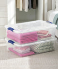 Heavy Duty 32 Quart Medium Clear Plastic Latching Storage Bin With Snap Tight Locking Lid Spill Resistant Container, stacked with towels.
