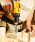 Person using drill with Pro Grade One Quarter Inch Shank Compression Router Bit Extra Long Four Inch Overall Length Two Inch Cutting Length DLC Coated
