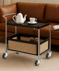Rolling cart with black top, chrome frame, and woven basket shelf on four swivel casters.