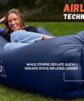 A person relaxing on an Inflatable Couch Air Lounger Chair No Pump Needed For Camping And Beach Trips, blue color, outdoor lawn setting.
