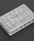 Pro Grade Watch Crown Kit With Copper And Stainless Steel Crowns in 12-slot organizer box on black surface.