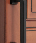 Close-up of 4 Inch Center To Center Square Cabinet Pull Handle Solid Cast Iron With Rust Resistant Black Powder Coat on wooden door