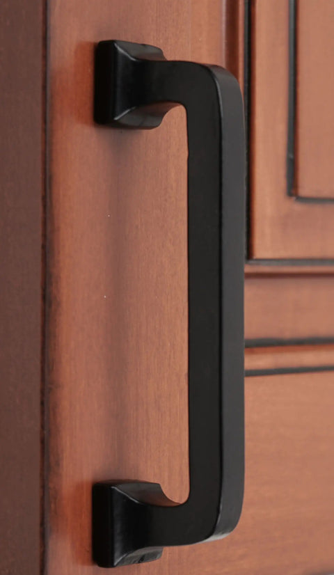Close-up of 4 Inch Center To Center Square Cabinet Pull Handle Solid Cast Iron With Rust Resistant Black Powder Coat on wooden door