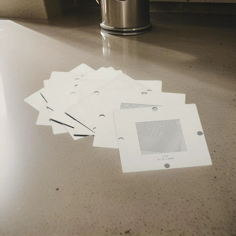 Stack of stencil templates from BGA Reballing Kit 90mm Reball Station Fixture Jig Set With 10 Stencil Templates And Metal PCB Holder