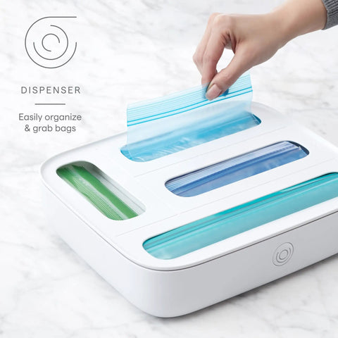 Hand using StoraBag Drawer Food Bags Dispenser For Kitchen Storage 4 Slot Plastic Sandwich Bag Organizer on countertop