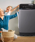 Compact Full Automatic Washing Machine In Sleek Grey with user and child, featuring a laundry basket and relaxed setting.