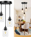 Slick Three Light Black Pendant Fixture With Crystal Clear Glass Shades and Fully Adjustable Suspension Cords above dining table.