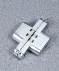Concealed Cross Hinges Set Of Two In 304 Stainless Steel for table and counter doors on a gray surface