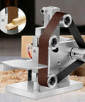 Pugermering Mini Belt Sander Electric Power Tool With Bench Grinder And Polisher Functions Adjustable Angle Worktable Compact Aluminum Alloy Design 30X300mm Ribbed Wheel Automatic Correction For DIY Projects, featuring a close-up of the sanding mechanism.