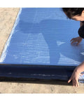 Applying Tough As Nails Bitumen Waterproof Tape With Sturdy Aluminum Foil Backing for leak fixes on a rooftop.