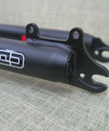 Close-up of black 26 inch mountain bike suspension fork with 1-1/8 threadless steerer, double shoulder triple tree design.