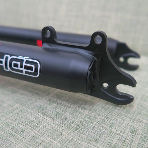 Close-up of black 26 inch mountain bike suspension fork with 1-1/8 threadless steerer, double shoulder triple tree design.