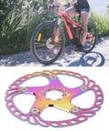 Person riding a mountain bike on a trail with Rock Solid Metal Disc Brake Pads For Mountain Bikes With Five Nail Design 203mm.