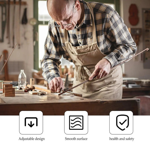 Man woodworking in workshop wearing plaid shirt and apron; focus on precision craft with tools on the table.