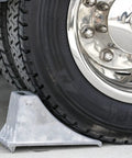 Close-up of Beefy Aluminum Wheel Chock With Rugged Teeth For Extra Grip And Stability Steep Slope Design 55000 Lb Capacity in use
