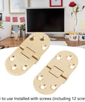 Brass Folding Flip Top Hinge Set For Folding Tables, Sewing Machines And Furniture, shown with screws on a desk