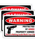 Kickass 3 Pack Gun Warning Signs For Home Security 10x7 Inch Rock Solid Rust Proof Aluminum Plaques visible stacked for outdoor use.