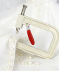 All In One Pearl Setting Kit With 4085 Beads And Nails For DIY Pearl Setting Machine Hand Press Beading Tool on white fabric with pearls.