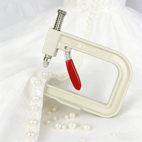 All In One Pearl Setting Kit With 4085 Beads And Nails For DIY Pearl Setting Machine Hand Press Beading Tool on white fabric with pearls.
