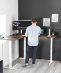Vivo Electric L Shaped Corner Standing Desk With Memory Height Adjustment And White Finish For Office Ergonomic Sit Stand Workstation in use.