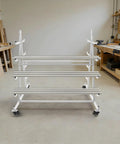 Heavy Duty Five Tier Lumber Storage Rack Double Sided Wood Organizer With Smooth Rolling Brake Casters in a workshop.