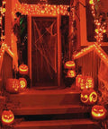 Front porch decorated for Halloween with jack-o'-lanterns and Two Pack Solar Christmas String Lights With Remote And Timer in warm white.