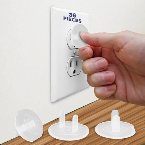 Hand inserting Baby Proof Outlet Covers 36 Pack White No Sweat Easy Press In Fit for unused outlets and socket safety caps