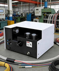 Automatic Electric Wire Twister And Stripper Machine With 3 Brushes For Shielded Cables, black and white unit on a workshop table.