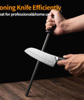 Person sharpening a knife with a 12 Inch Honing Steel Knife Sharpener Rod For Kitchen Knives And Scissors Hard As Steel With Gift Box