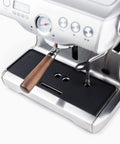 Badass Non Slip Silicone Tamping Mat For Dual Boiler Espresso Machines Includes Vented Drip Tray on a silver espresso machine.