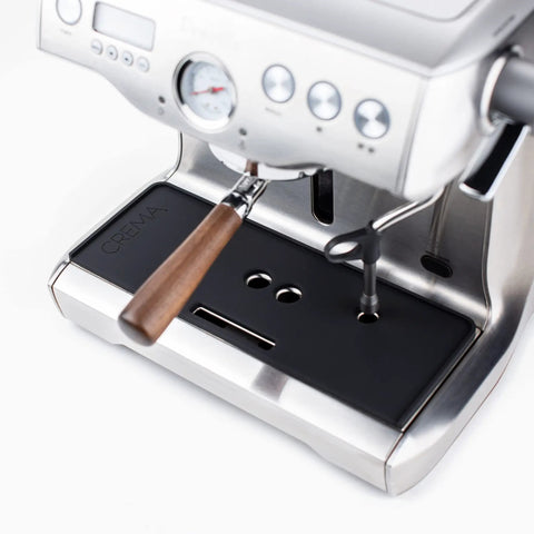 Badass Non Slip Silicone Tamping Mat For Dual Boiler Espresso Machines Includes Vented Drip Tray on a silver espresso machine.