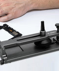 Phone LCD Display Separator Pro Tool For Quick Screen Removal on a table next to electronic components