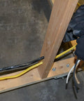 Installer wiring 25 Ft 6-3 NM-B Cable NMWG Ground For Residential In-Wall Wiring, showing hands connecting cables in wood frame