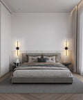 Slick Black Cordless Wall Sconces Set Of Two Wireless Led Accent Lamps With Smooth Stepless Dimming And Handy Remote illuminating a modern bedroom.